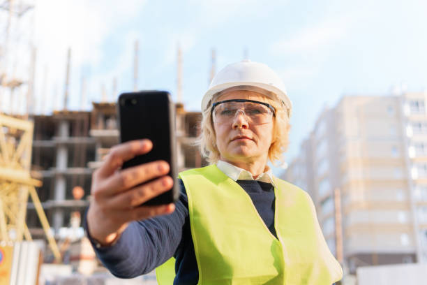 istock A female builder worker at a construction site works and controls the process. 1369504858