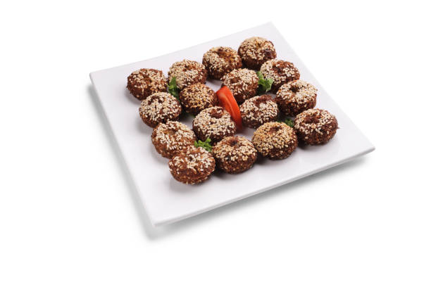 Studio shot of an arab dish falafel on a square white plate isolated on white background