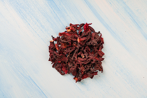 Dried hibiscus on blue background