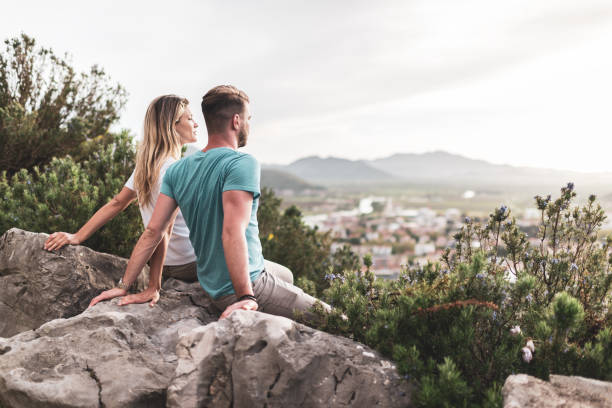 istock Young couple enjoying mountains at sunset 1369507681