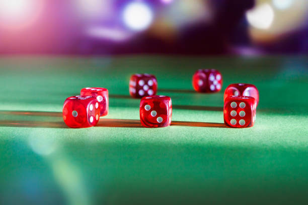 istock Dice playing on green felt on a dark background 1369508293