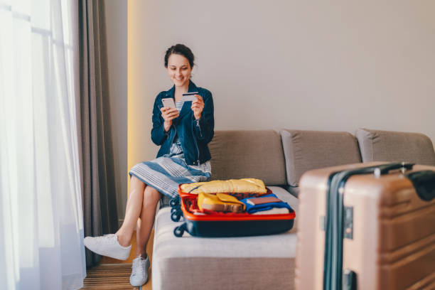 istock Tourist in hotel room flight reservations 1369508547