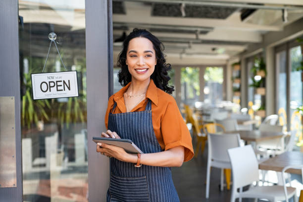 istock Small business entrepreneur at cafe entrance using digital tablet 1369508588