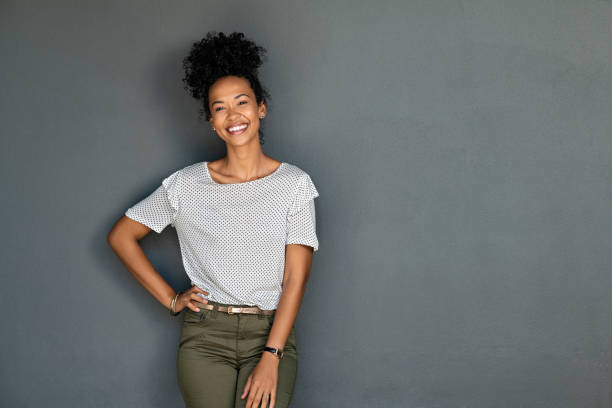 istock Confident young black woman isolated on grey wall 1369508677