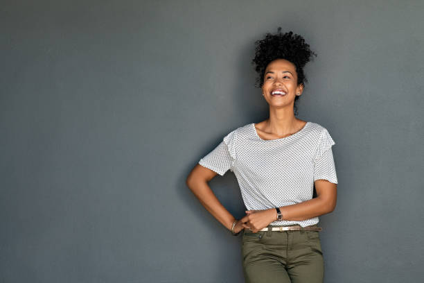 istock Laughing young black woman isolated on grey background 1369508734