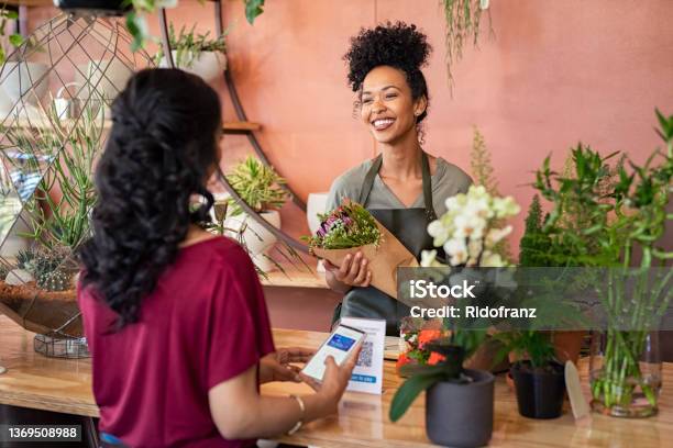 Happy Friendly Florist Giving Fresh Bouquet To Customer Stock Photo - Download Image Now