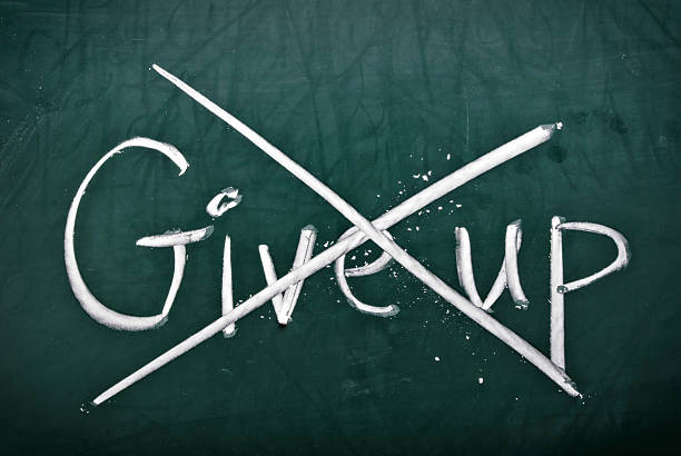 istock Give up written down which has been crossed out in defiance 136950974