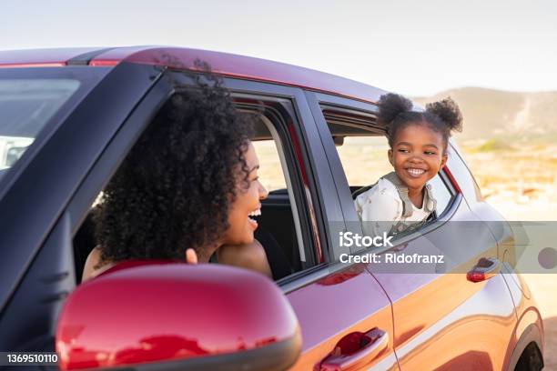 Mother And Black Daughter Peeping Outside Car Stock Photo - Download Image Now - Car, Family, Road Trip