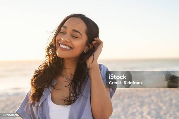 Carefree Beautiful Latin Woman Relaxing On Beach Stock Photo - Download Image Now - Women, Happiness, Smiling