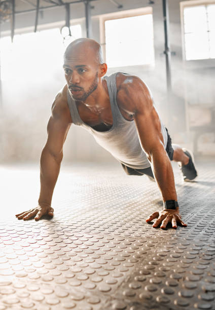 istock Shot of a young man completing a push up 1369510526