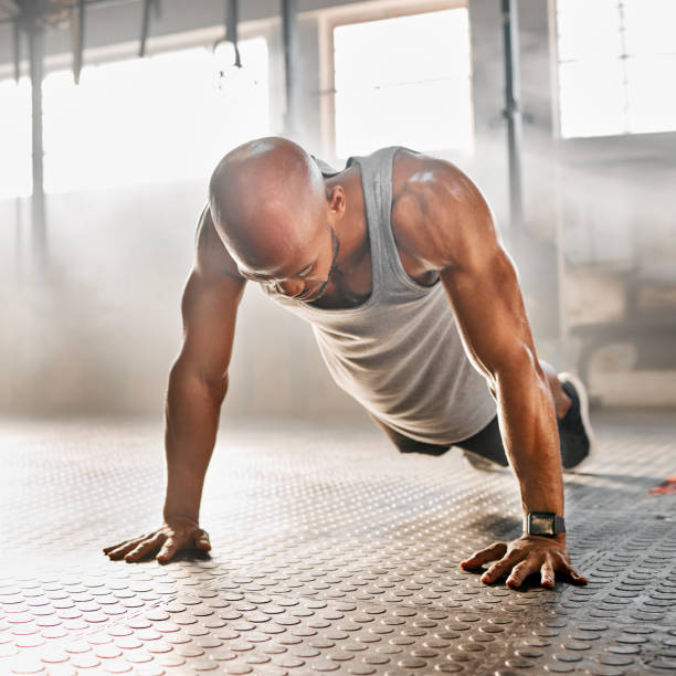 istock Shot of a young man completing a push up 1369510569