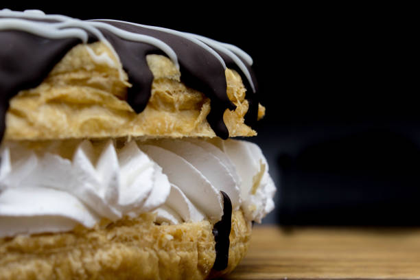 Delicious bakery display of cream filled chocolate frosted donuts