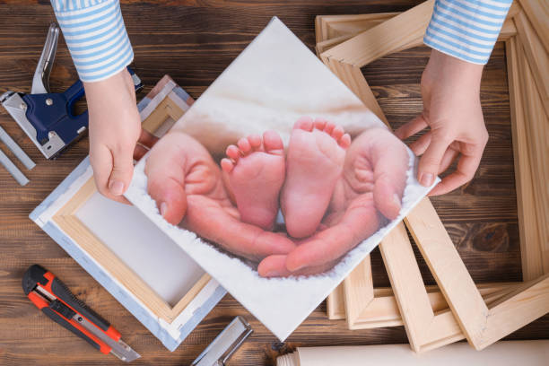 istock The master demonstrates a photo printed on canvas and stretched on a stretcher. 1369510740