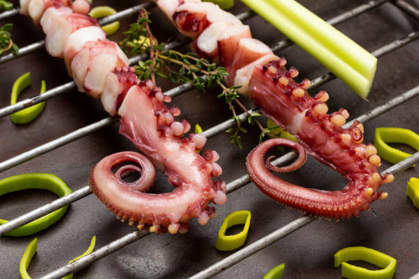 istock Grilled octopus tentacles. Rusty metal background. 1369510779