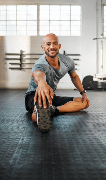 istock Shot of a young man stretching his legs before a workout 1369512000