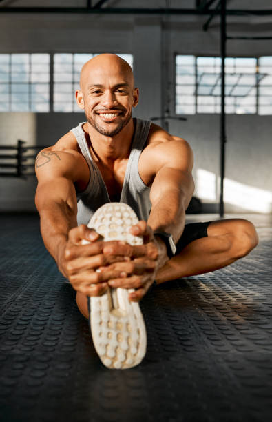 istock Shot of a young man stretching his legs before a workout 1369512002