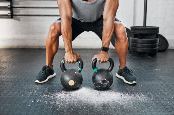 istock Shot of a man completing squats with a kettlebell 1369512048