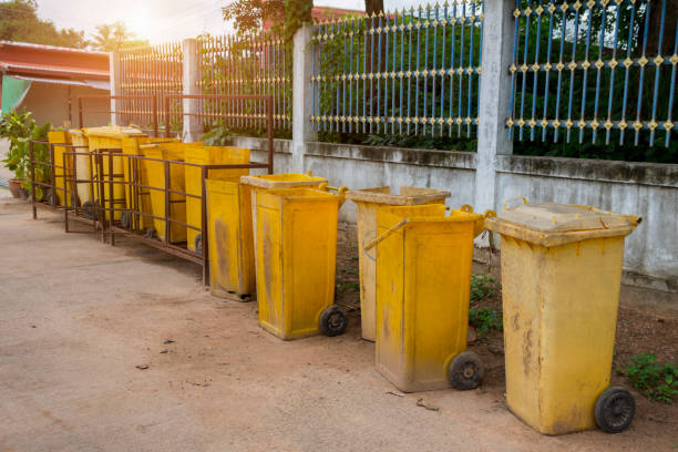 istock Yellow trash can is placed on the side of the road. 1369513199