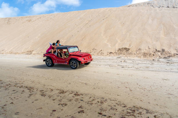 Tourists on dune buggy travelling on Genipabu Beach