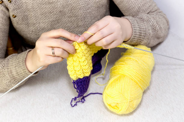 istock Female hands knitting needles sweater close-up 1369513680