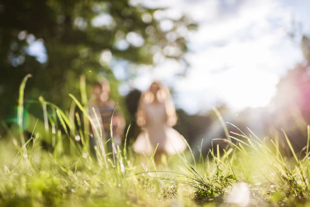 Blurred beautiful smiling brother and sister running in nature on a sunset.