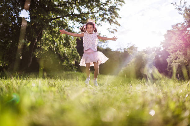 istock Beautiful girl jumping in nature 1369514459