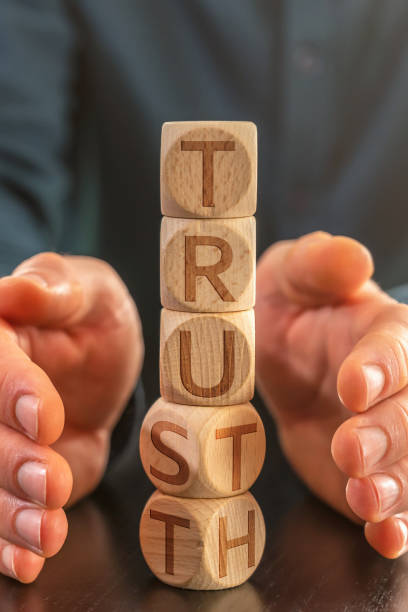 istock Superimposed cubes with the words trust and truth with hands as frame 1369515745