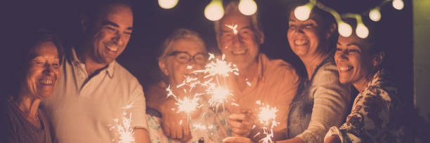 istock Midsection Of Woman Holding Illuminated String Lights At Night 1369516105
