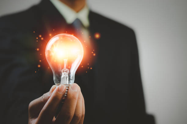 istock hand holding light bulb ideas Great inspiration and innovation 1369516929