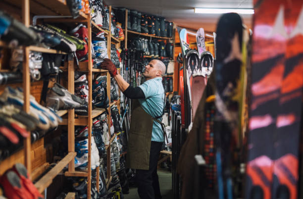 Ski retail and repair shop owner working.