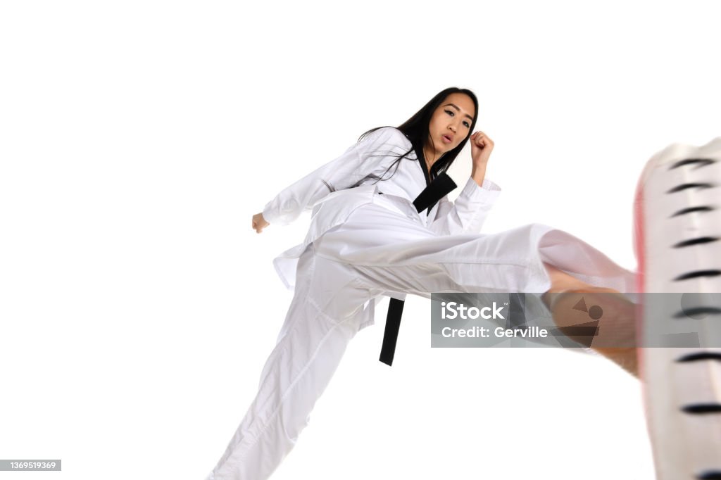 Martial Arts Padded Target Training Martial artist executing a sparring roundhouse kick on a padded target. 25-29 Years Stock Photo