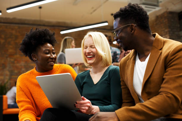 istock Young managers are sitting, smiling, and talking. Start-up. 1369520751