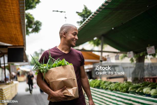 Young man walking in a street market