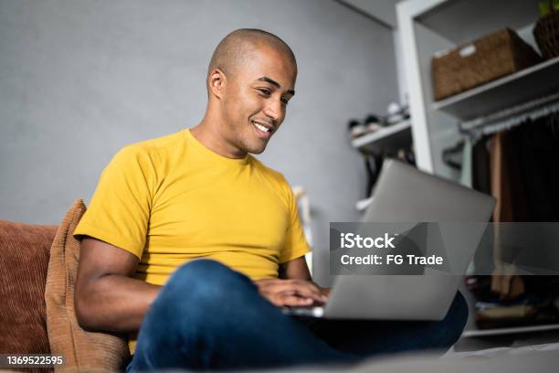 Young Man Using The Laptop In The Bed At Home Stock Photo - Download Image Now - Using Laptop, Domestic Life, Laptop