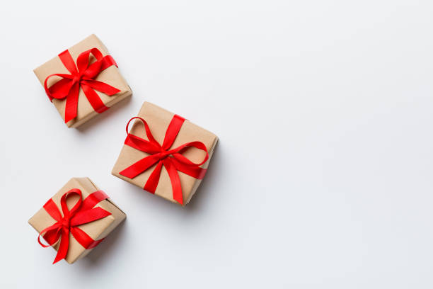 istock Valentine day composition: red gift box with bow and heart. Christmas present. View from above. Space for text. Holday greeting card 1369522832