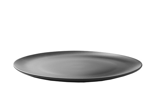 Black ceramic round plate isolated over white background. perspective view.