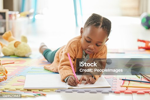 istock Shot of a little girl relaxing and drawing 1369523463