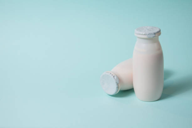 istock Bottles with probiotics and prebiotics dairy drink on light blue background. 1369523705