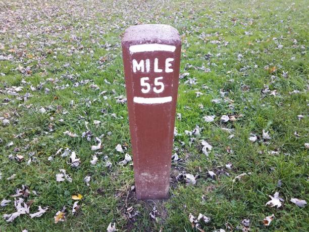 istock mile marker 55 or post in ground with grass 1369523727