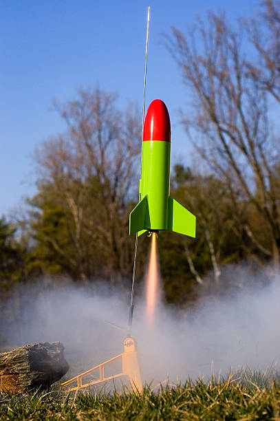 Toy Rocket Takeoff Toy rocket launches off the pad with plenty of fire and smoke. model rocket stock pictures, royalty-free photos & images