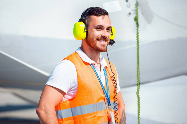 airport ground service, man in front of airplane - ground crew audio imagens e fotografias de stock