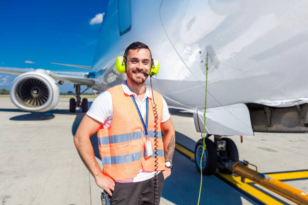 airport ground service, man in front of airplane - ground crew audio imagens e fotografias de stock