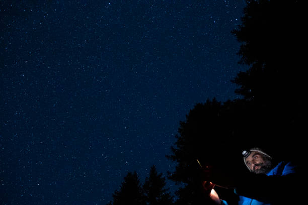 istock Man at night with his smartphone in nature. 1369525373