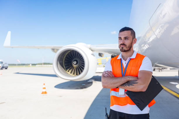 istock Airport service crew in front of airplane 1369525765