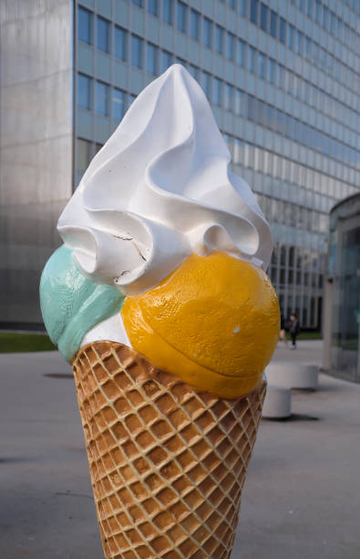 istock Ice Cream Cone Display in front of a modern skyscraper 1369526500