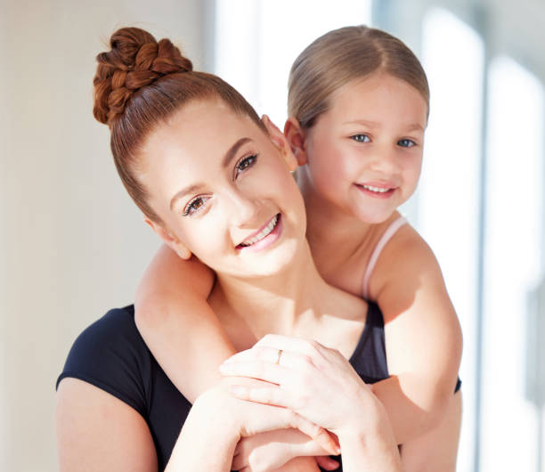 istock Shot of a ballet teacher and student in a dance studio 1369527039