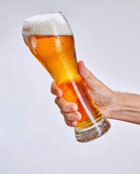 istock hand holding glass of beer 1369528130