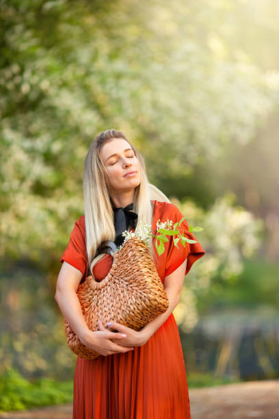 istock Young beautiful woman enjoys a blooming spring garden 1369528538