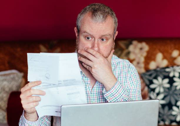 istock Worried man checking bills at home 1369529119