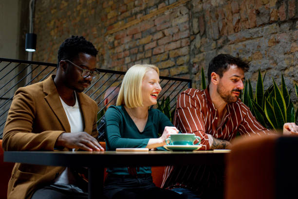 istock Three young business persons are sitting at the table and talking. Start-up. 1369529662